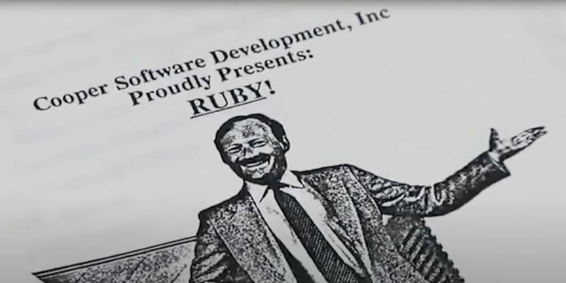 A photograph of a printed manual titled 'Cooper Software Development, Inc proudly presents: RUBY!' which has an image of a happy man in a suit with arms wide open.